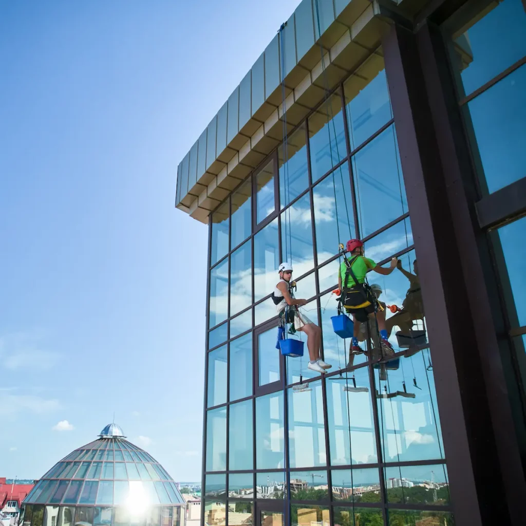 Image of two workers cleaning high-level windows
